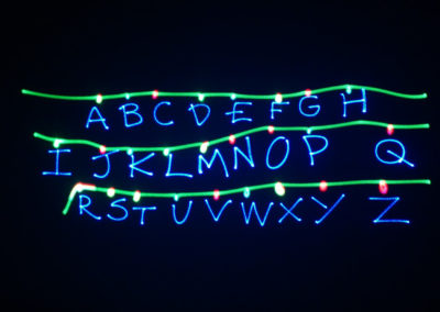 Green and blue lasers writing out the alphabet