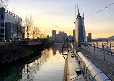 USS Requin with the City of Pittsburgh in the background at dusk