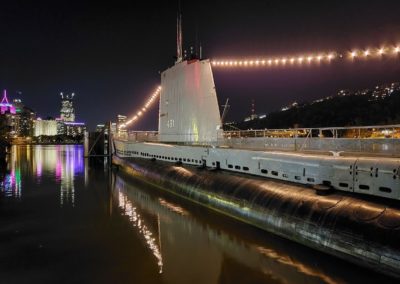 USS Requin with the City of Pittsburgh in the background at night
