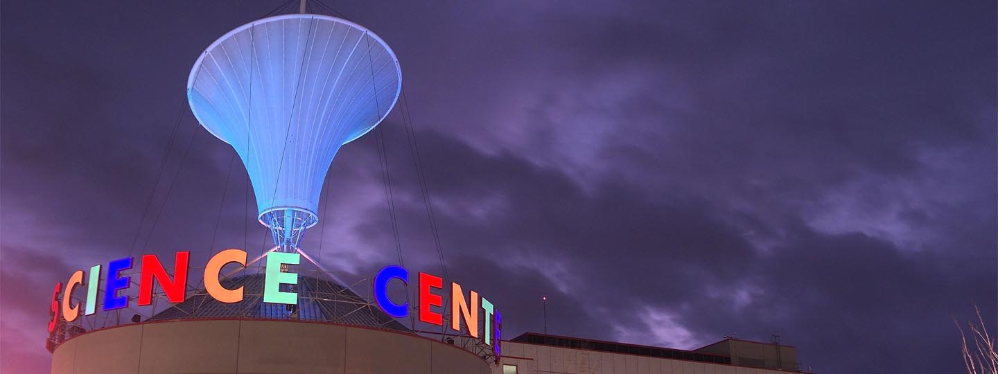 The e-Motion cone in the night sky with Science Center letters lit up in different colors
