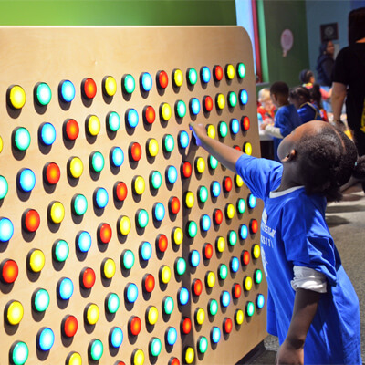 Girl at a button wall