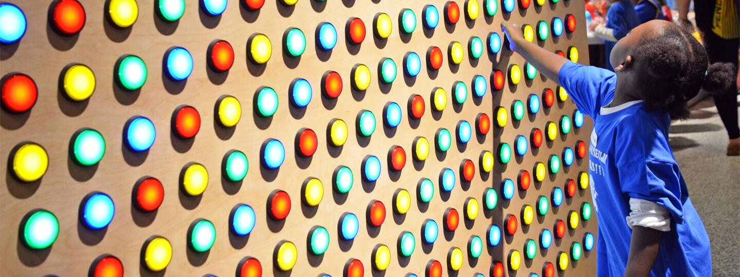 Girl at a button wall