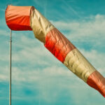 A wind sock with dark clouds in the background.