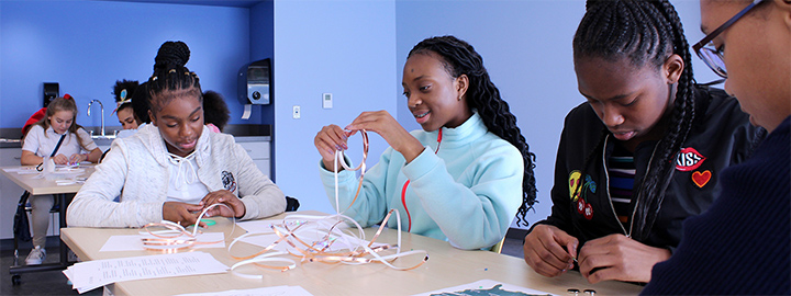 Students at a table constructing a project