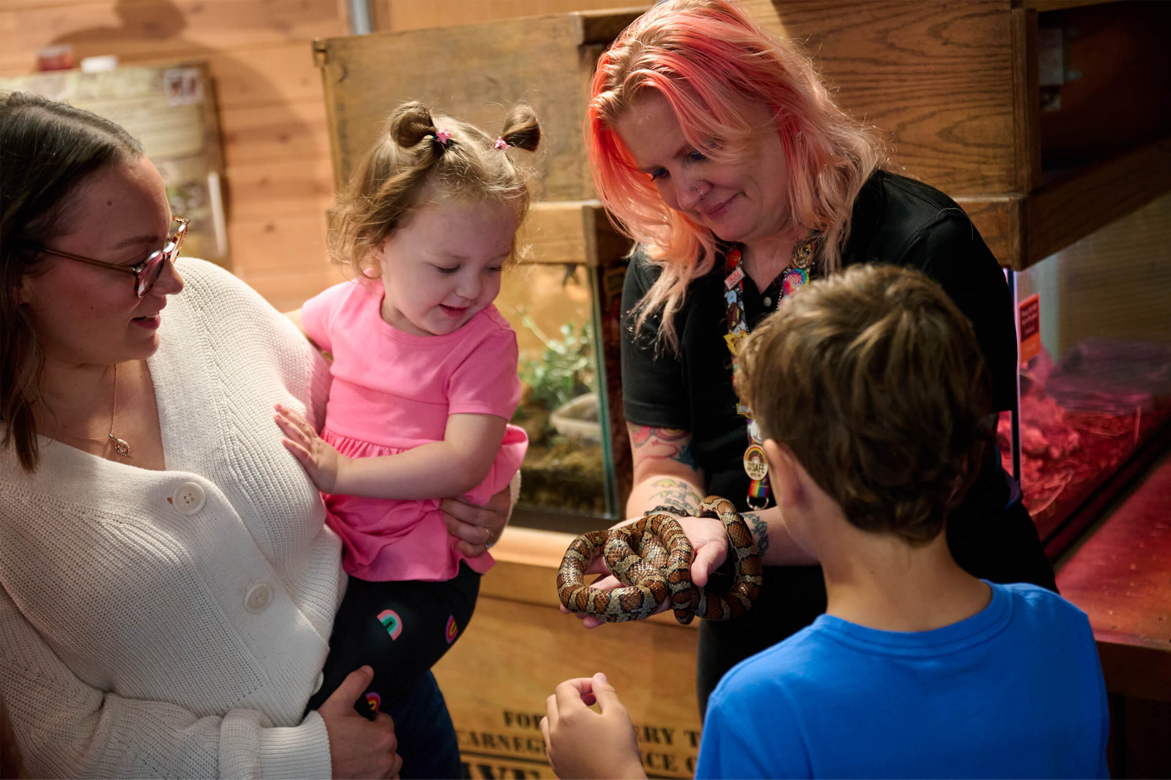 Staff member showing guests a snake
