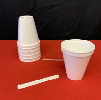 Stack of paper cups and a straw