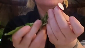 Hand holding top of cut radish