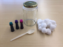 Jar, spoon, food coloring, and cotton balls