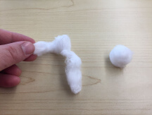 Hand holding cotton, a cotton ball