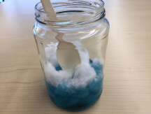 Jar with green liquid, cotton, and spoon