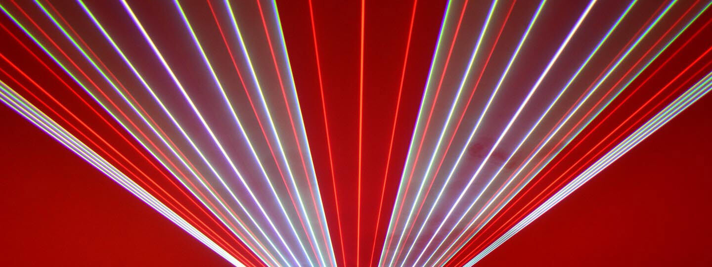 Red, white, and purple lasers fanning out from the bottom middle of the picture