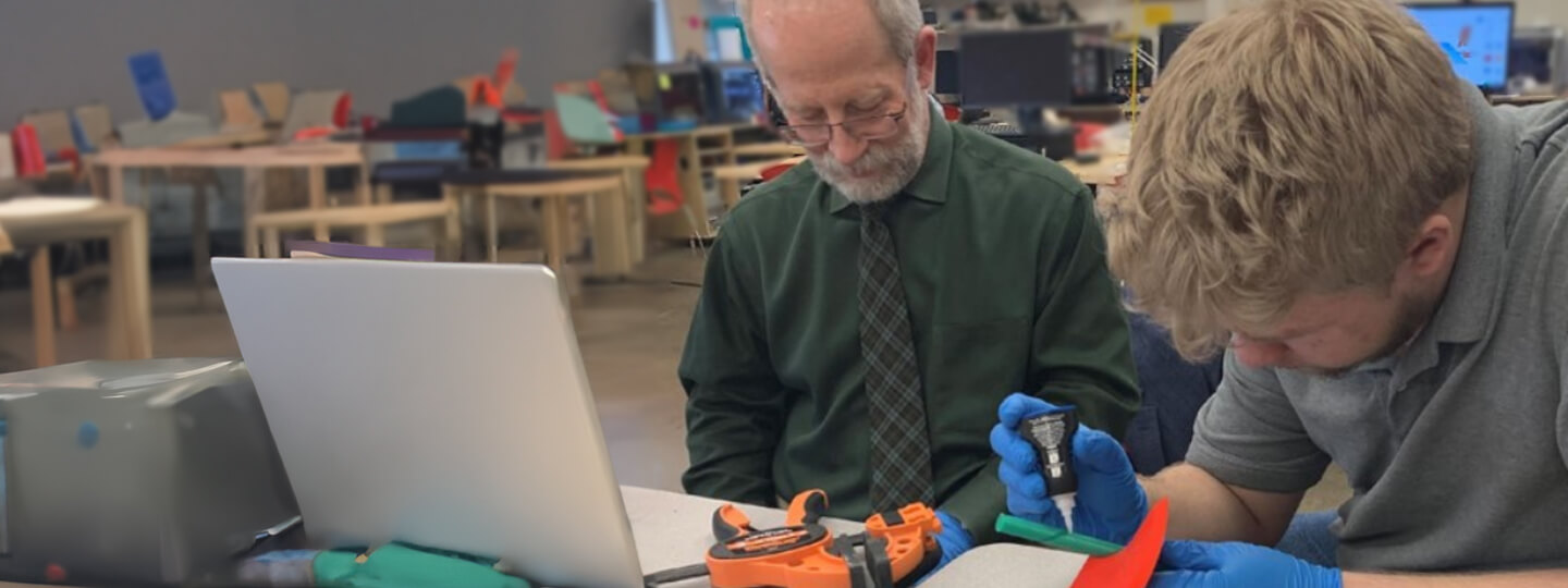 Teacher with a student that is working on a project