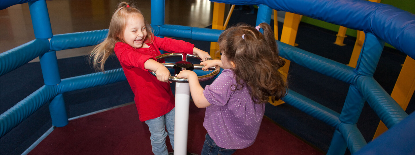 Two little girls on spinning platform