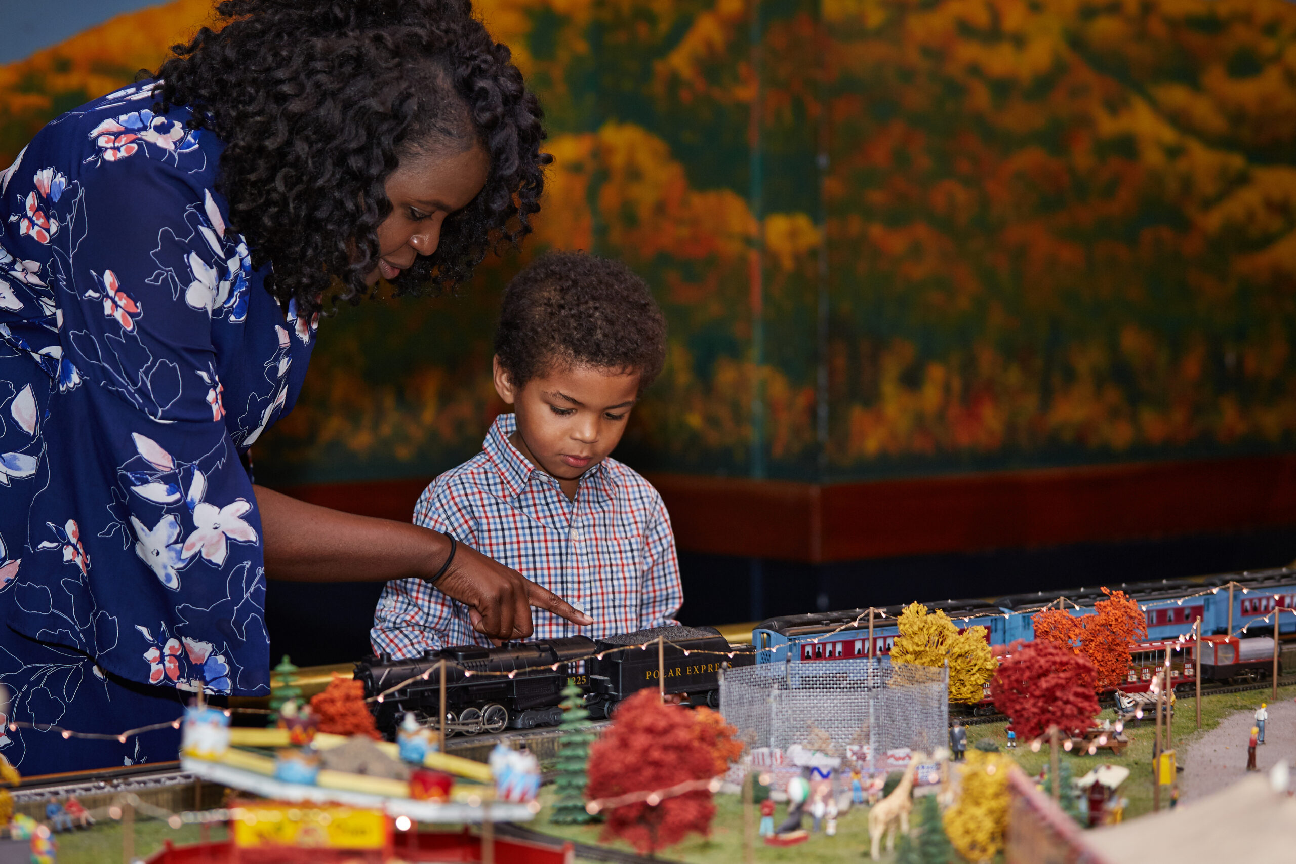 Mother and child looking at model trains