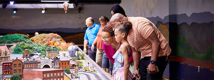 Family looking at the railroad display