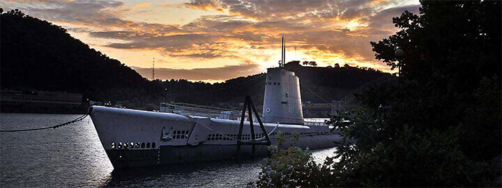 The USS Requin submarine in the water at dusk