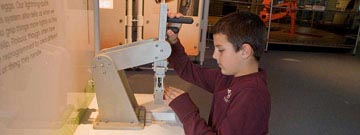 Boy interacting with a robotic arm