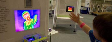 Boy interacting with a monitor with his thermal image