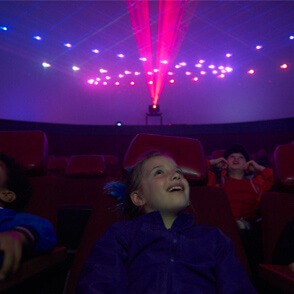 Kids sitting in a planetarium