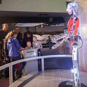 Family looking at a robot
