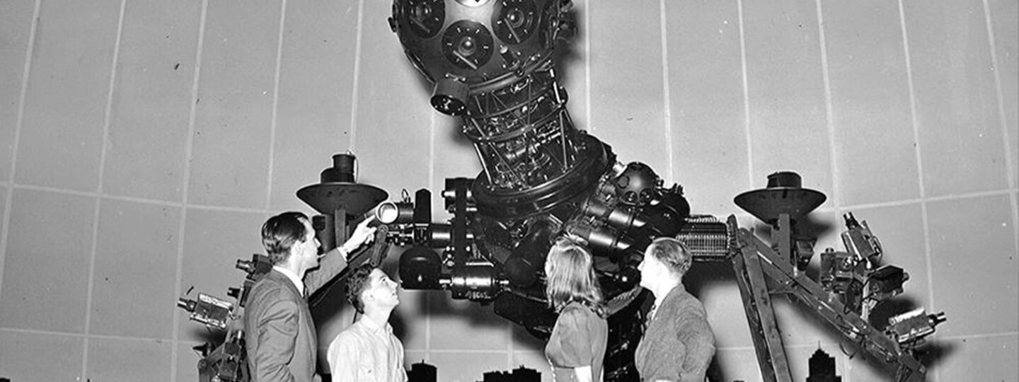Four people looking at The Zeiss projector