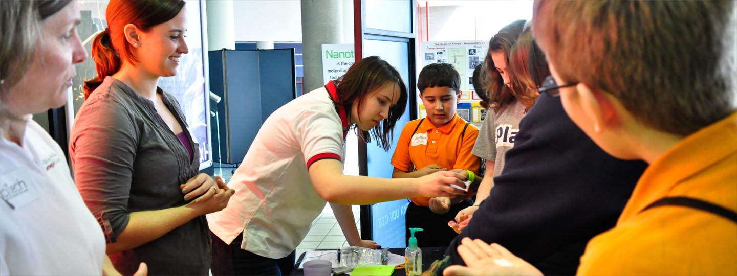 A Science Center employee giving a demonstration to a group of people in the STEM Center