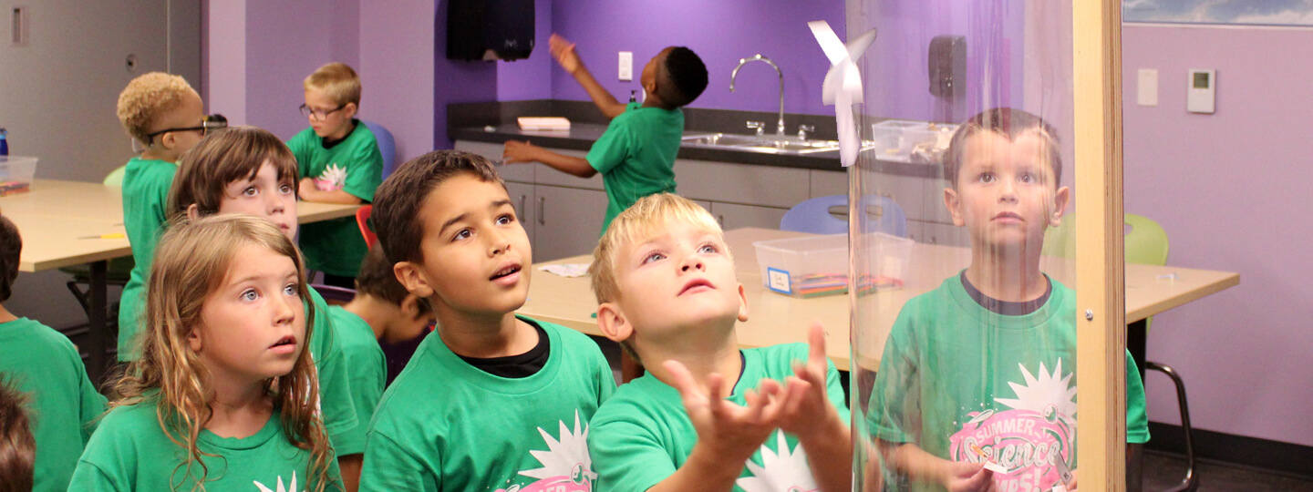 Children launching paper rockets