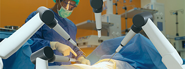 Surgeon operating with four robot arms